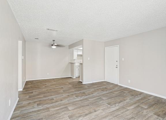A5 living room with vinyl wooden flooring at Windridge on the Parkway apartments in Dallas, TX