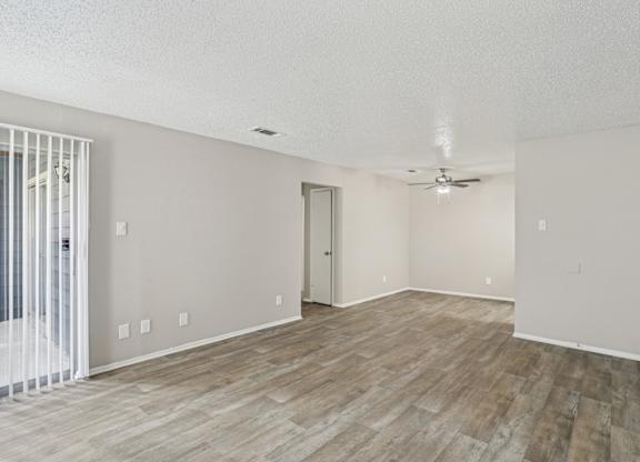 A6 living room with vinyl wood flooring and a ceiling fan Windridge on the Parkway apartments in Dallas, TX