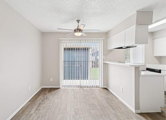 B6 dining room with a ceiling fan and wooden floor at Windridge on the Parkway in Dallas, TX
