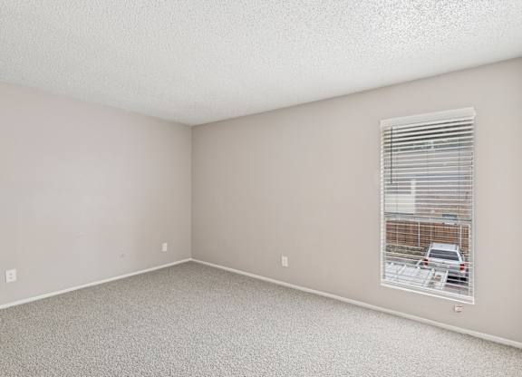 Carpeted B6 bedroom with a window at Windridge on the Parkway in Dallas, TX