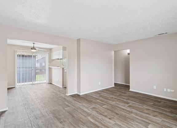 B6 living room with a sliding glass door leading to a balcony at Windridge on the Parkway in Dallas, TX