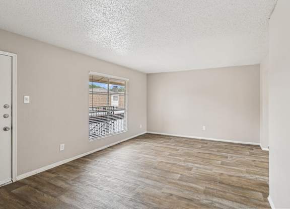 B6 living room with wooden flooring and a window at Windridge on the Parkway in Dallas, TX