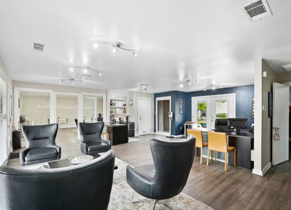 Interior of leasing office with a lot of comfortable seating at Windridge in Dallas, TX