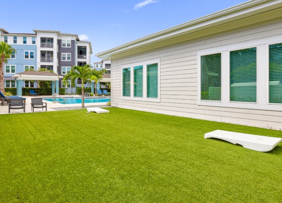 Corn hole boards by the pool at Dunedin Commons apartments in Dunedin, FL