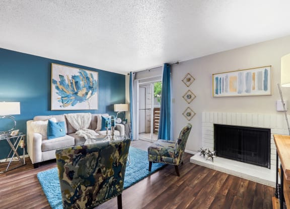 a living room with a couch chair and fireplace