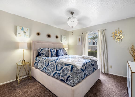 a bedroom with a bed and a window