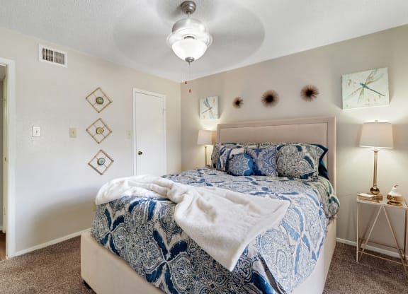 a bedroom with a bed and a ceiling fan