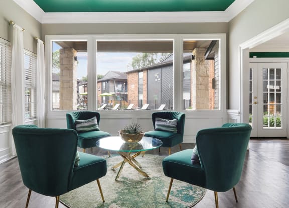 a living room filled with furniture and a large window