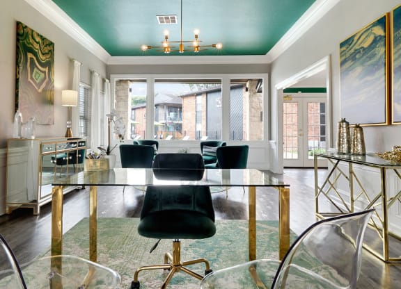 a dining room with a glass table and black chairs