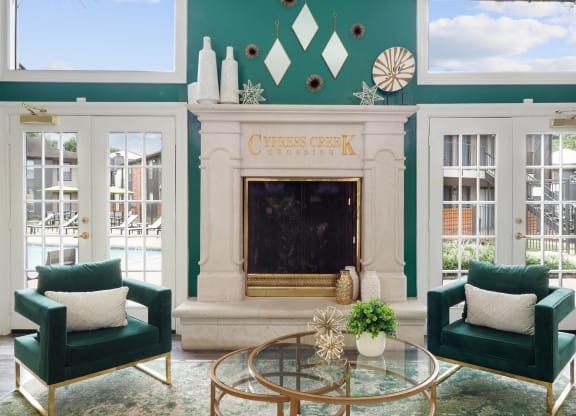 a living room with green walls and a fireplace