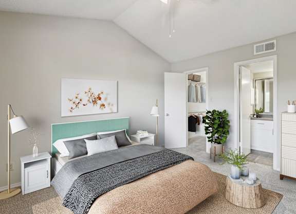 A bedroom with a large bed and a painting on the wall at Jefferson Creek Apartments in Irving, TX