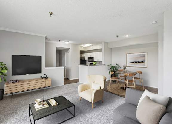 A gray living room with a comfortable sofa and TV at Jefferson Creek Apartments in Irving, TX