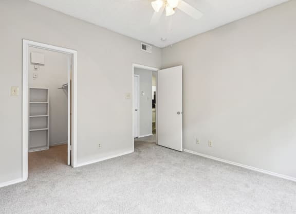 A1 floor plan bedroom with a ceiling fan at Jefferson Creek Apartments in Irving, TX.