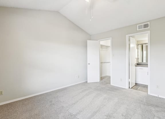 A3 floor plan bedroom with vaulted ceiling and private bathroom entrance at Jefferson Creek Apartments in Irving, TX.