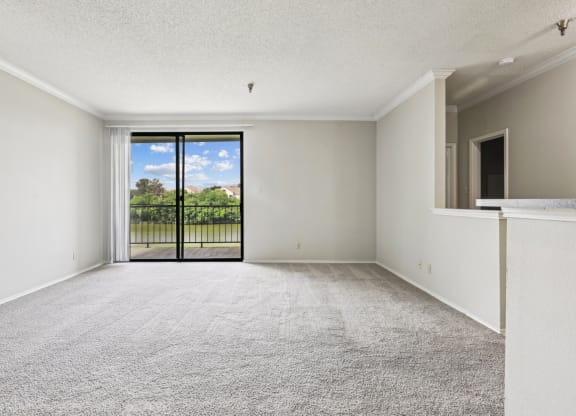 B1 living room with a sliding door to a balcony at Jefferson Creek Apartments in Irving, TX.