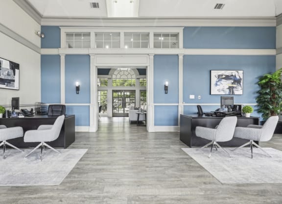 a lobby with blue walls and white furniture at Jefferson Creek in Irving, TX