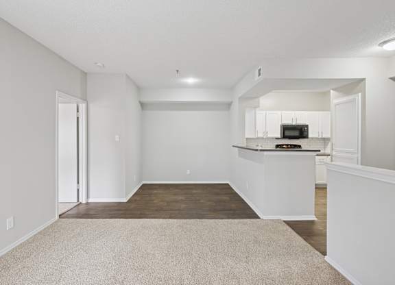 B2 living room with a kitchenette in the background at Jefferson Place Apartments in Irving, TX