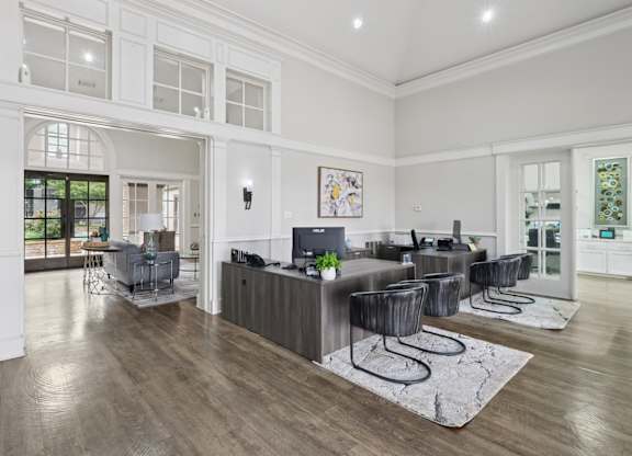 Leasing office with desks and a lounge area at Jefferson Place Apartments in Irving, TX