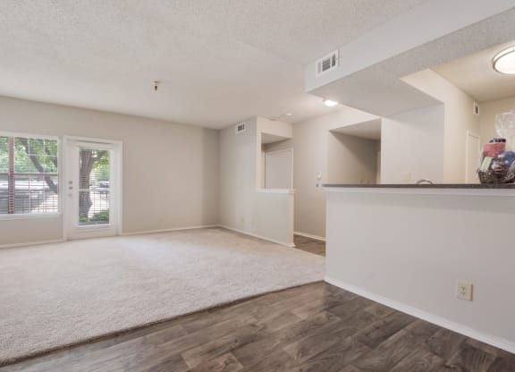 an empty living room with a door to a patio