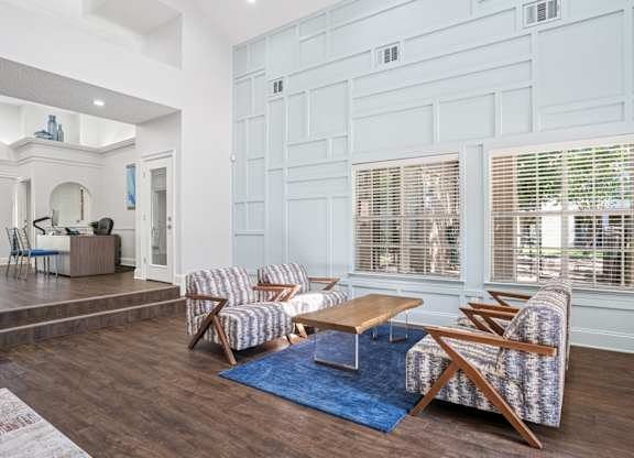 Clubhouse area in leasing office with seating and a coffee table.