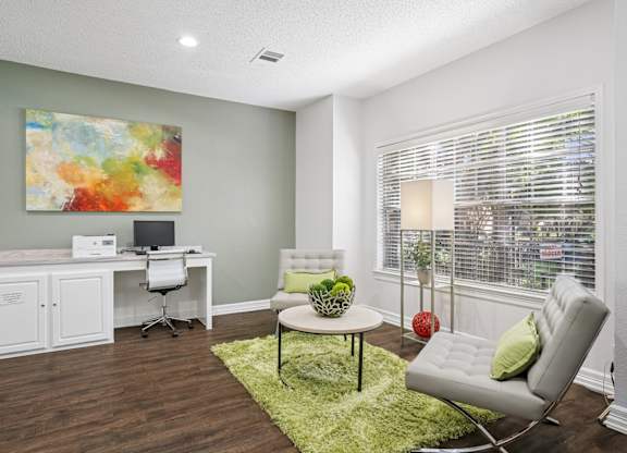 Business center with computer and seating with a coffee table at La Costa in Plano, TX