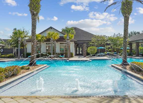 A pool with a fountain in the middle of it.