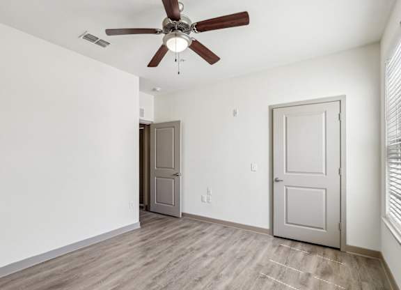 Royal Palm bedroom with a ceiling fan at Oakleaf Plantation apartments in Jacksonville, FL.
