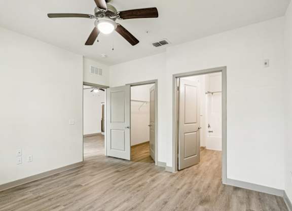 Royal Palm bedroom with a ceiling fan and vinyl wood flooring at Oakleaf Plantation apartments in Jacksonville, FL.