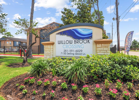 a photo of the willowbrook crossing sign in front of the building