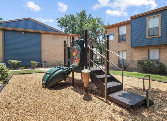 a playground at the whispering winds apartments in pearland, tx