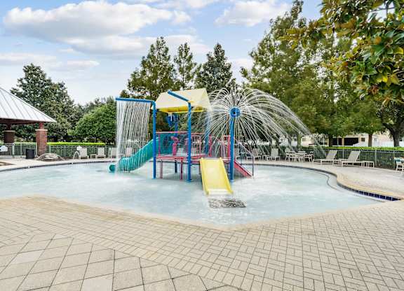 A water park with a slide and a waterfall at Wynnfield Lakes Apartments in Jacksonville, FL