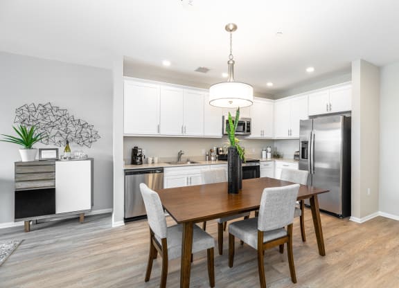 a kitchen and dining room with a table and chairs