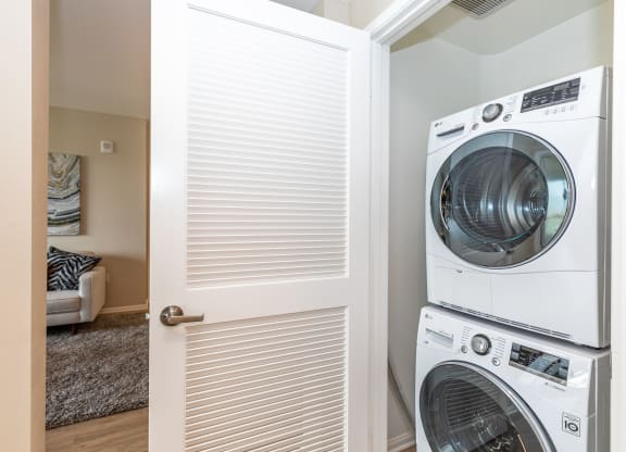 a door to a laundry room with a washer and dryer