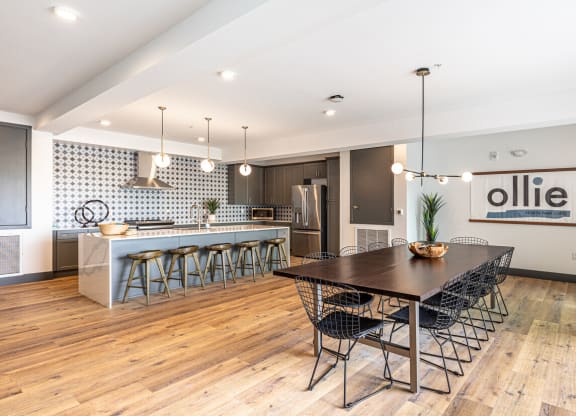 a dining room and kitchen with a table and chairs