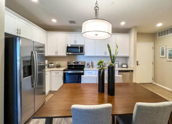 a kitchen and dining room with a wooden table