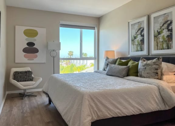 a bedroom with a large bed and a window