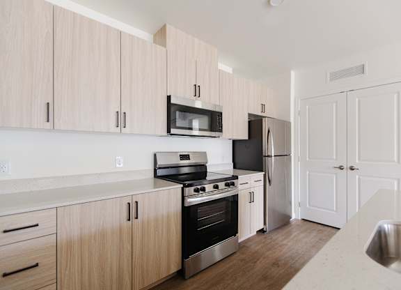 A kitchen with wooden cabinets and stainless steel appliances.