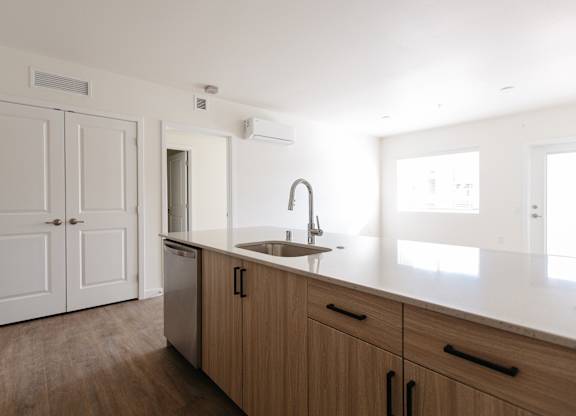 A kitchen with wooden cabinets and a white countertop.