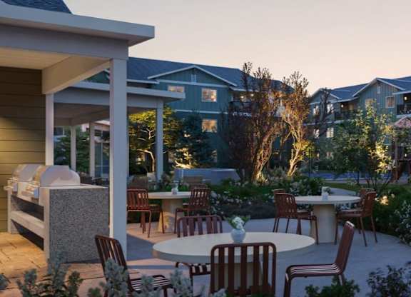 A patio with a table and chairs is set up outside a house.