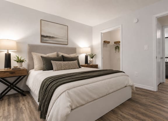 Bedroom with neutral tones and ensuite bathroom at Radius at the Domain Apartments, Austin, 78758