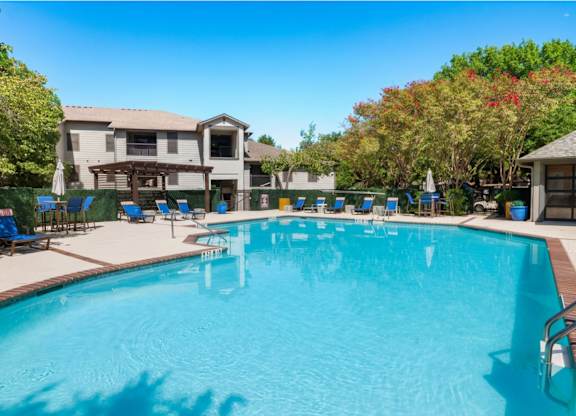 Resort style swimming pool with lounge chairs at Radius at the Domain Apartments, Austin, 78758