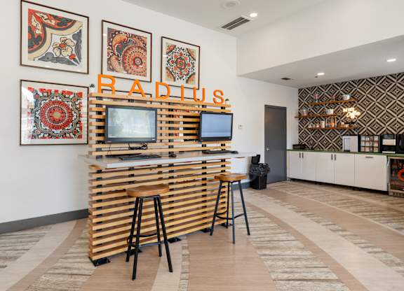 Business center with wood desk and computer workstations at Radius at the Domain Apartments, Texas
