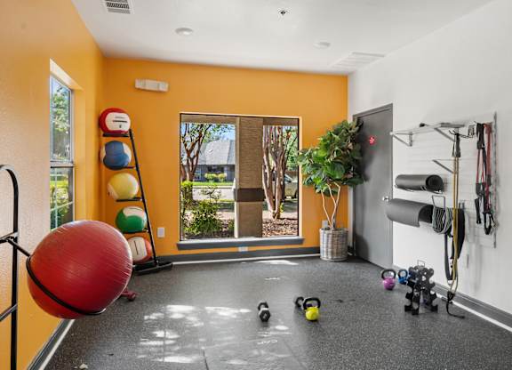 Fitness room with exercise balls and wall mounted equipment at Radius at the Domain Apartments, Austin, 78758