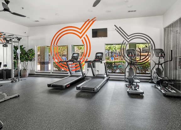 Fitness center with treadmills and elliptical machines at Radius at the Domain Apartments, Austin