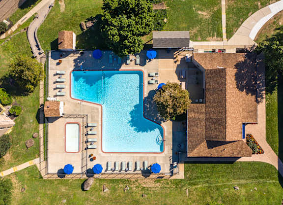 An aerial view of a house with a swimming pool.
