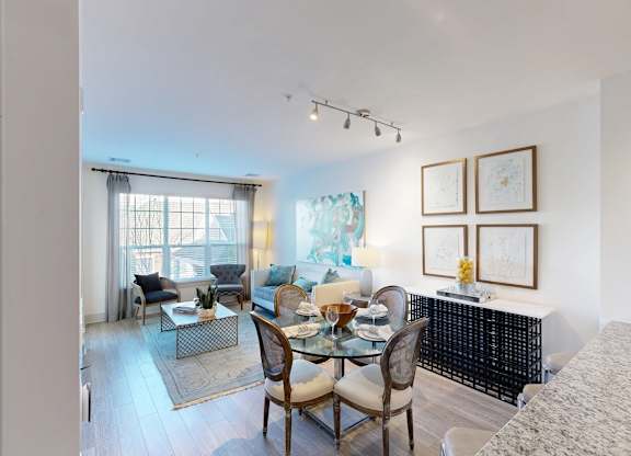 A dining room with a glass table and chairs.