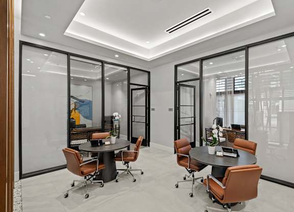 A conference room with a table and chairs.