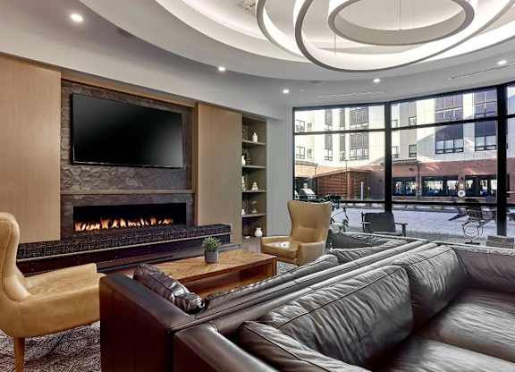 A modern living room with a fireplace and a television.