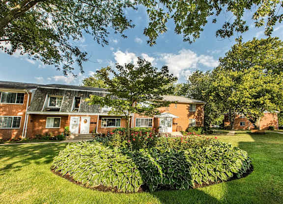 A building with a green lawn in front of it.