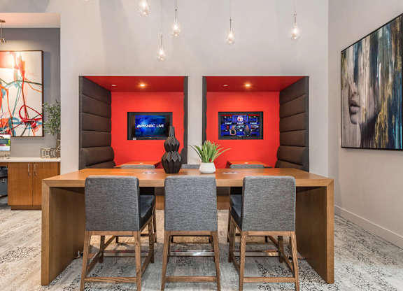 A conference room with a long table and chairs.